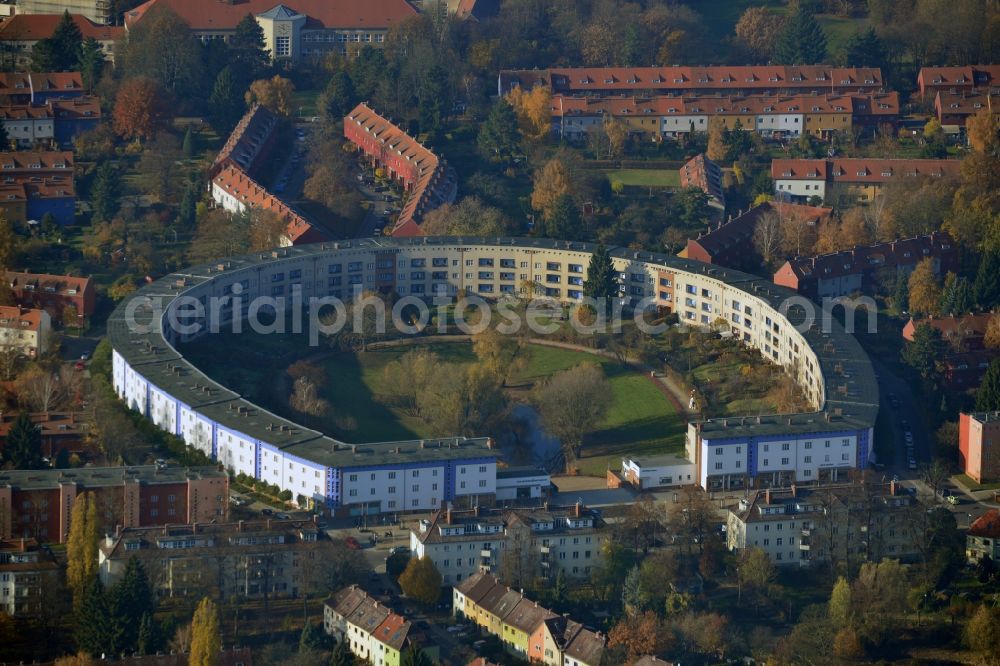 Berlin from above - View of Horseshoe settlement in Berlin-Britz. The Hufeisensiedlung was builded from 1925 to 1933 in Berlin-Britz, designed by Bruno Taut and Martin Wagner. It is one of the first projects of social housing and part of the large settlement Britz / Fritz Reuter city. Since 2008 it has been a UNESCO World Heritage Site. The horseshoe itself is still owned by the GEHAG, under the roof of the Deutsche Wohnen AG