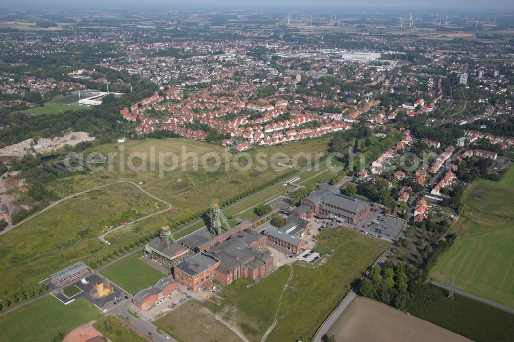 Ahlen from above - Colony of westphalia. Residential area of a multi-family house settlement at the Schachtstrasse in Ahlen in the state North Rhine-Westphalia. In the picture the former coal mine. Today, the site is used as a commercial space and venue