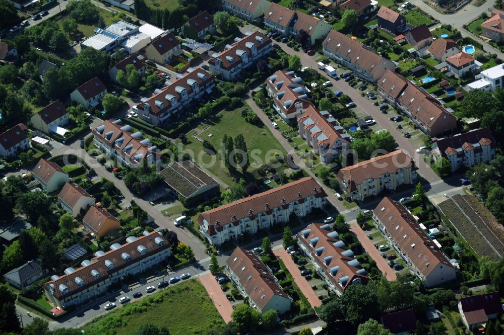 Berlin from above - Residential area of a multi-family house settlement in the Bohnsdorf part of Berlin in Germany. The area consists of several apartment buildings, multi-family houses and residential estates on Fritz-Kuehn-Strasse. Green areas, parks and meadows are sitting amidst the buildings