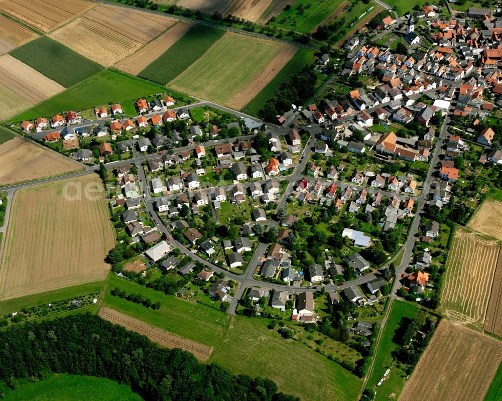 Aerial image Muschenheim - Residential area - mixed development of a multi-family housing estate and single-family housing estate in Muschenheim in the state Hesse, Germany