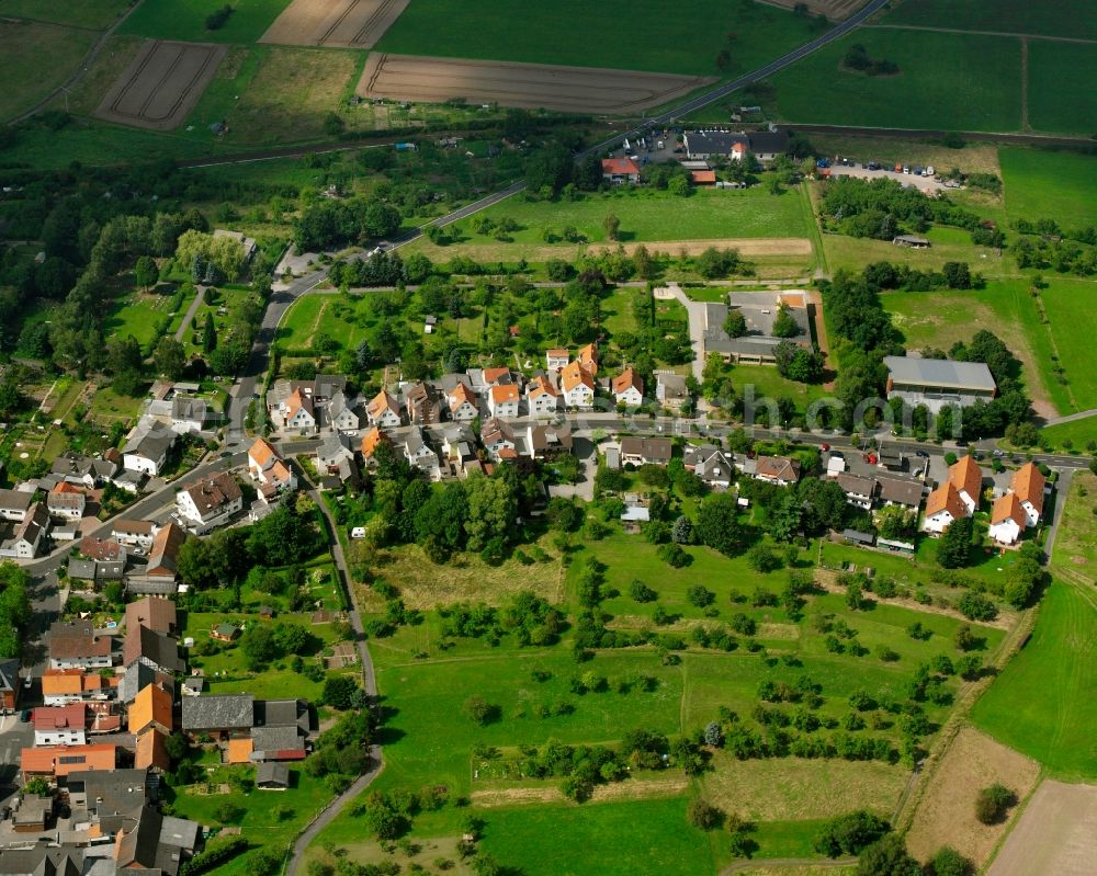 Rödgen from the bird's eye view: Residential area - mixed development of a multi-family housing estate and single-family housing estate in Rödgen in the state Hesse, Germany