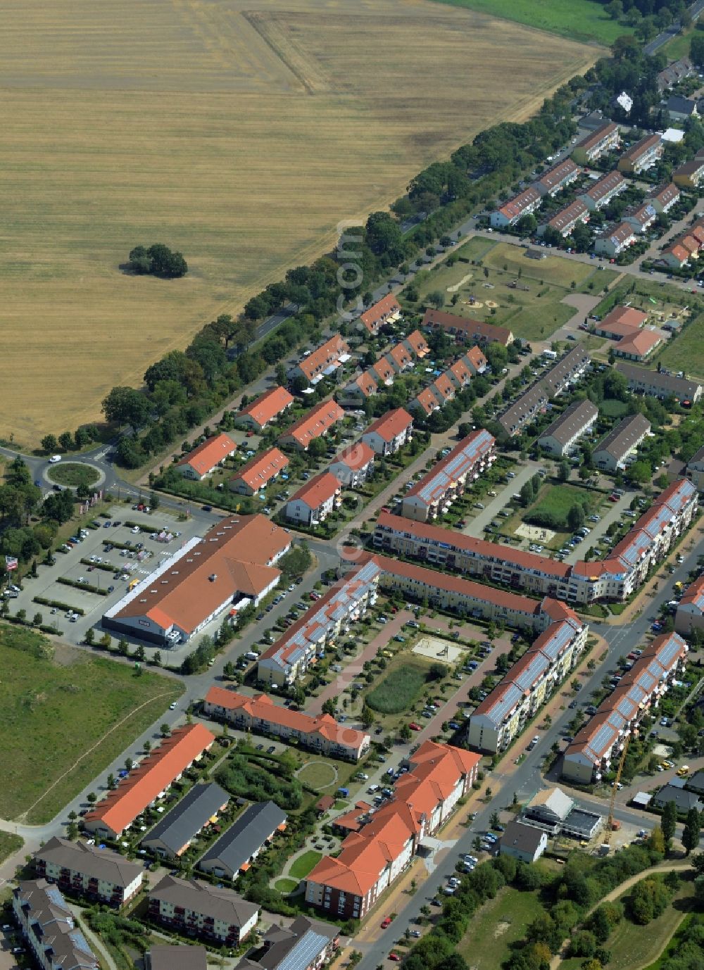 Hoppegarten from above - Residential area on the North Eastern edge of Hoppegarten in the state of Brandenburg. The area with its symmetrically lined up residential buildings and estates is located on a field between the streets Am Wall and Brandenburgische Strasse