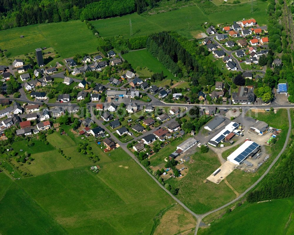 Höhn from the bird's eye view: Residential area in the borough of Hoehn in the state of Rhineland-Palatinate. The borough is located in the county district and region of Westerwald. The residential village is surrounded by fields and meadows. It sits right on federal highway B255 and consists of several parts