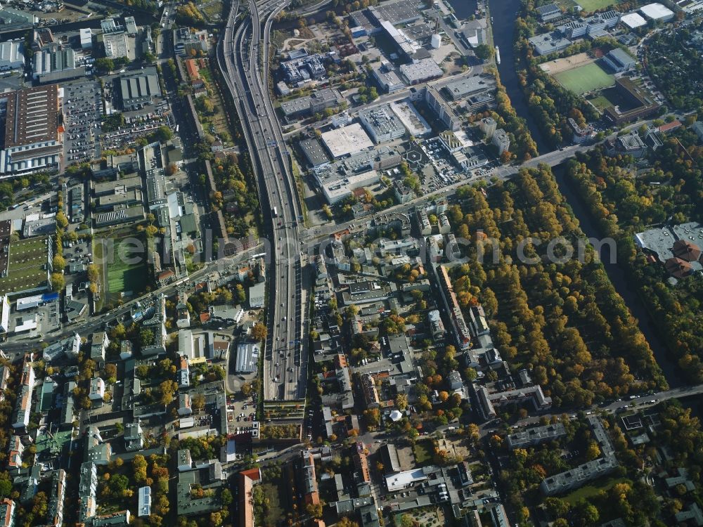 Berlin from the bird's eye view: Residential area with the tunnel exit of federal motorway A100 in the area of Buschkrugallee in the Neukoelln part of Berlin in Germany. An industrial and commercial area is located in the East of the area. Teltow canal takes its course in the South of the area