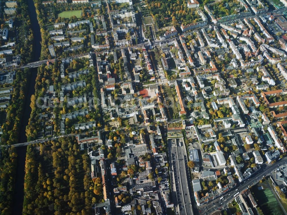 Aerial photograph Berlin - Residential area with the tunnel exit of federal motorway A100 in the area of Buschkrugallee in the Neukoelln part of Berlin in Germany. An industrial and commercial area is located in the East of the area. Teltow canal takes its course in the South of the area