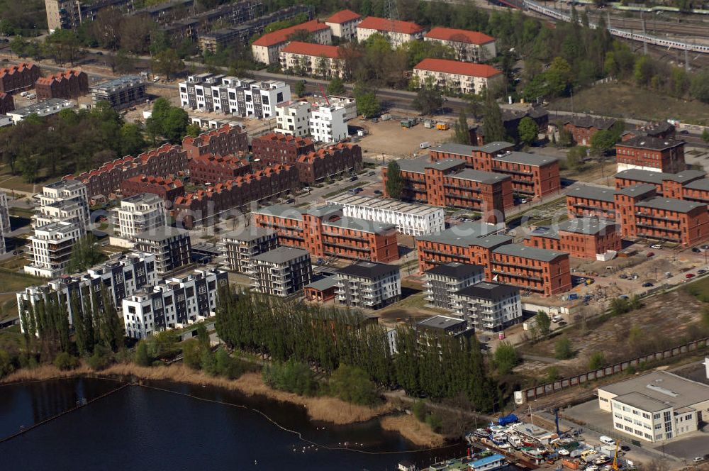 Aerial photograph Berlin - Blick auf das Rummelsburger Ufer, ein Teil der Rummelsburger Bucht mit dem Rummelsburger See. Hier enstehen bzw. entstanden Wohnungen als auch Einfamilienhaäuser im Neubau und Altbau. Speziell hierfür umgebaut sind die denkmalgeschützten ehemaligen JVA Gebäude der Haftanstalt / Justizvollzugsanstalt Rummelsburg. Einbezogen in die Bautätigkeit wurden sechs so genannten Verwahrhäuser des Gefängnisses, der Turm des ehemaligen Heizhauses, das Wäschereigebäude sowie das einstige Lazarett.