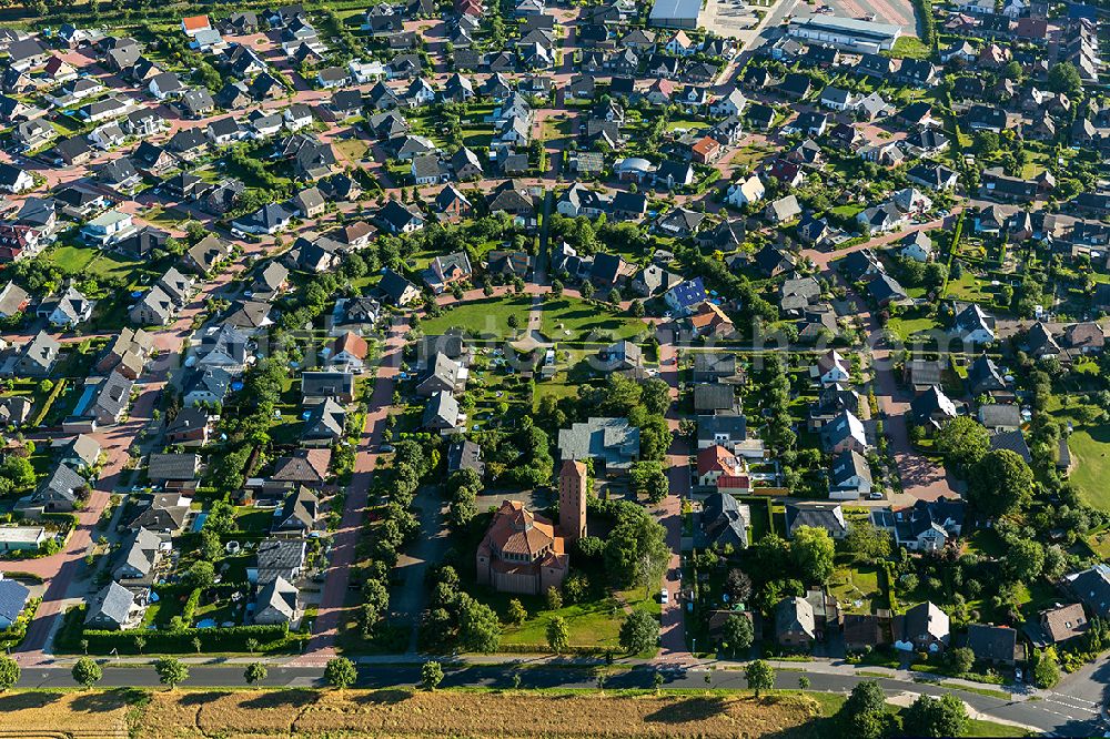 Bedburg-Hau from above - Residential area in a horseshoe layout with a social center and a playground in the village of Hau Reindershof to the Church of St. Anthony in Bedburg Hau-Hau on the Lower Rhine in North Rhine-Westphalia