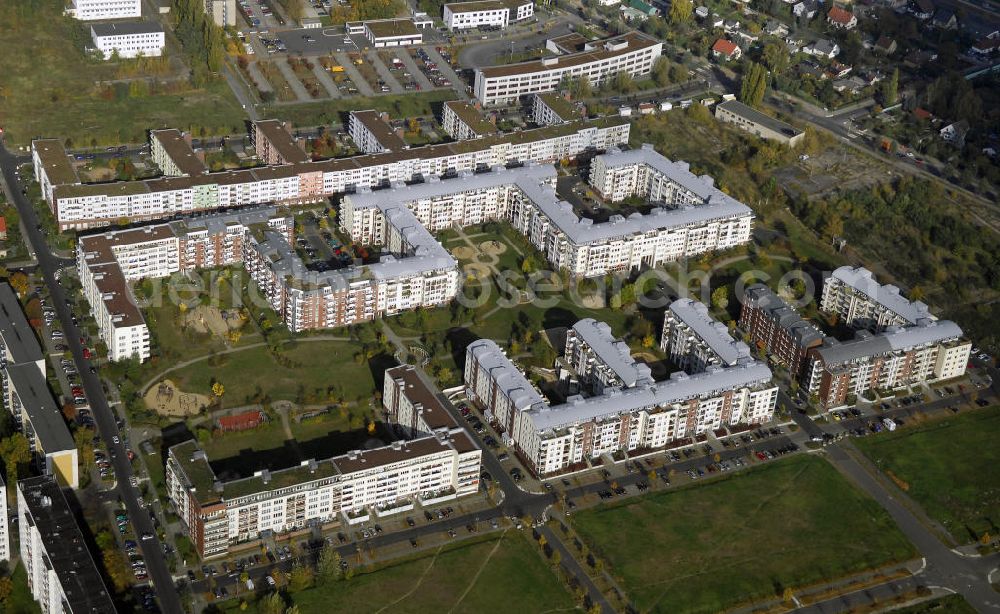 Aerial photograph Berlin - Blick auf das Wohngebiet Weiße Taube in Berlin Hohenschönhausen. Die Wohnhäuser entstanden auf dem Gelände einer ehemaligen Gärtnerei in raumklimatisch gesunder Ziegelbauweise. Ebenfalls entstanden Kindertagesstätten, sowie Geschäfte, Arztpraxen, Büros und gastronomische Betriebe. Kontakt Vermietung: KCC Max Aicher Objekt Berlin GmbH & Co. KG, Vermietungsbüro: Schalkauer Straße 29, 13055 Berlin, Tel. +49(0)30 98608730; Kontakt Aicher: Ma Aicher GmbH & Co. KG, Teisenbergstraße 7, 83395 Freilassing, Tel. +49(0)8654 491 0, Fax +49(0)8654 491 210, Email: immobilien@max-aicher.de