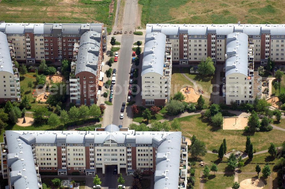 Aerial photograph Berlin - Blick auf das Wohngebiet Weiße Taube in Berlin Hohenschönhausen. Die Wohnhäuser entstanden auf dem Gelände einer ehemaligen Gärtnerei in raumklimatisch gesunder Ziegelbauweise. Ebenfalls entstanden Kindertagesstätten, sowie Geschäfte, Arztpraxen, Büros und gastronomische Betriebe. Kontakt Vermietung: KCC Max Aicher Objekt Berlin GmbH & Co. KG, Vermietungsbüro: Schalkauer Straße 29, 13055 Berlin, Tel. +49(0)30 98608730; Kontakt Aicher: Ma Aicher GmbH & Co. KG, Teisenbergstraße 7, 83395 Freilassing, Tel. +49(0)8654 491 0, Fax +49(0)8654 491 210, Email: immobilien@max-aicher.de