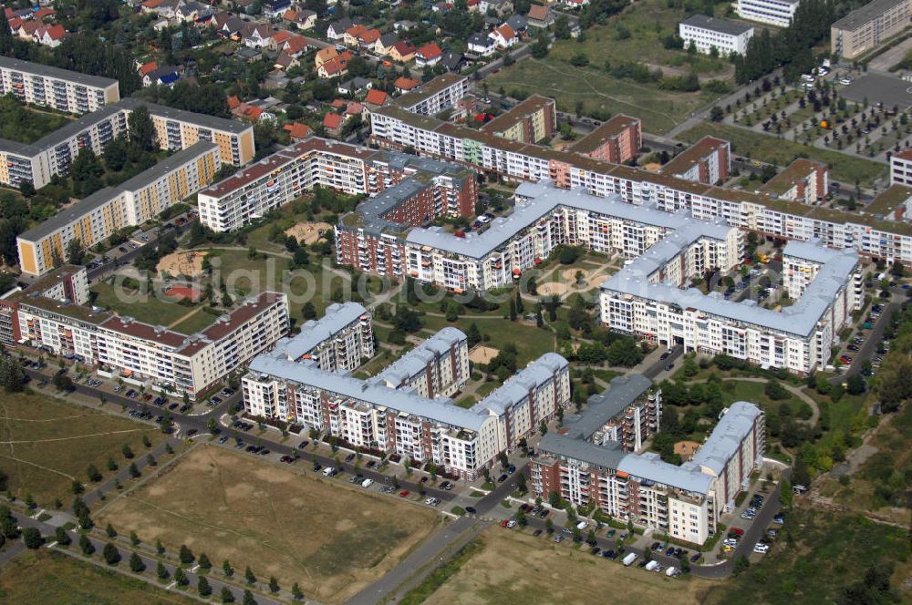 Aerial photograph Berlin - Blick auf das Wohngebiet Weiße Taube an der Landsberger Allee / Schalkauer Strasse in Berlin - Hohenschönhausen.Auf dem Gelände einer ehemaligen Gärtnerei entstanden in raumklimatisch gesunder Ziegelbauweise geförderte 1,5 bis 4-Zimmerwohnungen von ca. 50 bis über 100 m², zwei Kindertagesstätten, Räumlichkeiten für eine gemischte gewerbliche Struktur: Geschäfte, Arztpraxen, Büros und gastronomische Betriebe - rundum ein umfassendes Güter- und Dienstleistungsangebot in einem weitgehen?????????????????????????????????????????????????????????????????????????????????????????????????????????????????????????????????????????????????????????????????????????????????????????