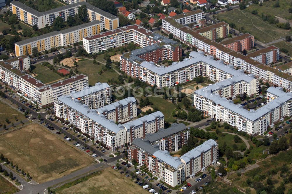 Aerial photograph Berlin - Blick auf das Wohngebiet Weiße Taube an der Landsberger Allee / Schalkauer Strasse in Berlin - Hohenschönhausen.Auf dem Gelände einer ehemaligen Gärtnerei entstanden in raumklimatisch gesunder Ziegelbauweise geförderte 1,5 bis 4-Zimmerwohnungen von ca. 50 bis über 100 m², zwei Kindertagesstätten, Räumlichkeiten für eine gemischte gewerbliche Struktur: Geschäfte, Arztpraxen, Büros und gastronomische Betriebe - rundum ein umfassendes Güter- und Dienstleistungsangebot in einem weitgehen?????????????????????????????????????????????????????????????????????????????????????????????????????????????????????????????????????????????????????????????????????????????????????????