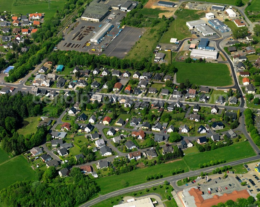 Aerial photograph Höhn - Residential area in the centre of the borough of Hoehn in the state of Rhineland-Palatinate. The borough is located in the county district and region of Westerwald. The residential village is surrounded by fields and meadows. It sits right on federal highway B255 and consists of several parts