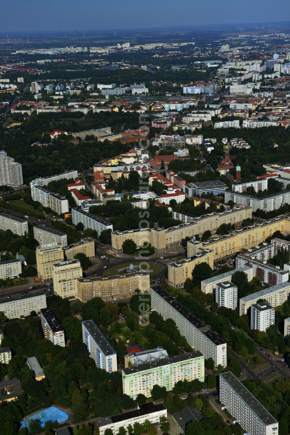 Berlin Friedrichshain from above - View of the Strausberger Platz with fountain in the district Friedrichshain of Berlin. The Strausberger Platz marks the border to the borough Mitte. The place was arranged 1967 after a fountain, designed by Fritz Kühn, had been constructed