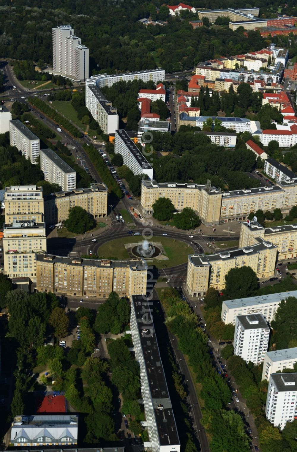 Aerial image Berlin Friedrichshain - View of the Strausberger Platz with fountain in the district Friedrichshain of Berlin. The Strausberger Platz marks the border to the borough Mitte. The place was arranged 1967 after a fountain, designed by Fritz Kühn, had been constructed