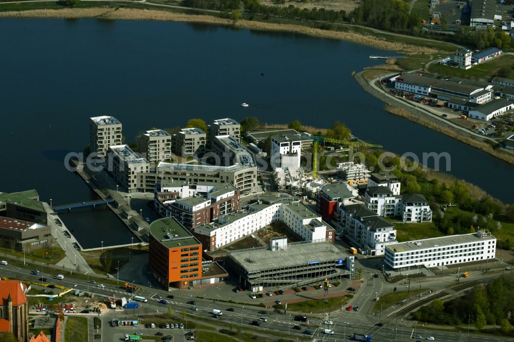 Aerial image Rostock - Multi-family housing estate, commercial building, parking garage and hotel complex on the wooden peninsula in Rostock in the state Mecklenburg-Western Pomerania, Germany