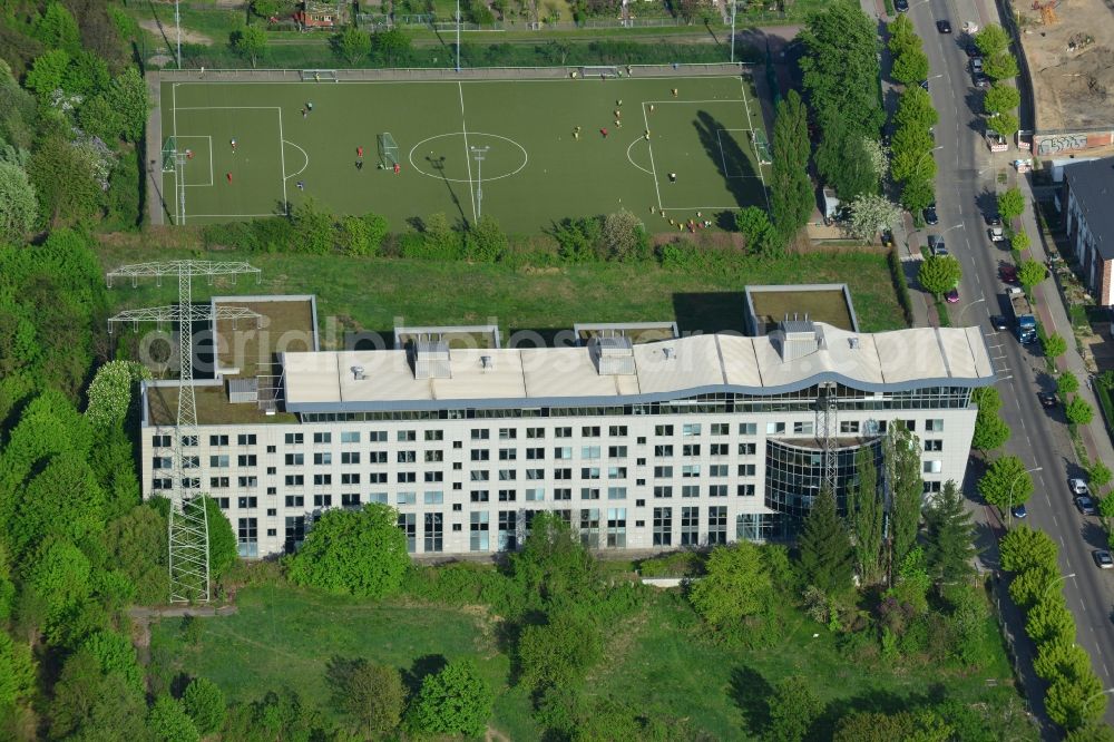 Berlin from above - Residential building and football pitch in the Lichtenberg part of Berlin in Germany. The building and the sports facilities area located - surrounded by trees and green areas - on Bornitzstrasse