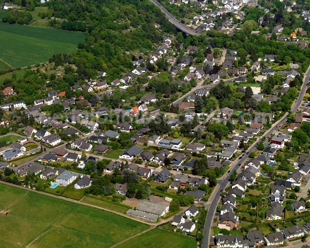 Andernach from above - Residential buildings and gardesn on the edges of Andernach in the state of Rhineland-Palatinate. The town is located in the county district of Mayen-Koblenz on the left riverbank of the river Rhine. The town is characterised by industry, consists of five boroughs and districts and belongs to the oldest towns in Germany. The edge of Andernach is home to residential streets, allotments and single family houses which border fields and meadows