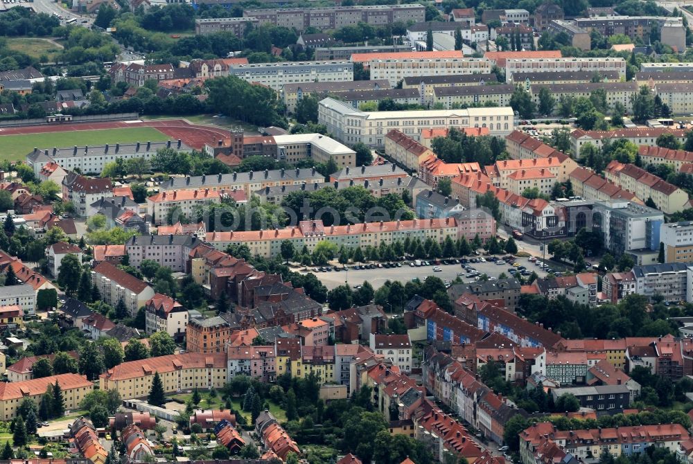 Nordhausen from the bird's eye view: The residential and business area around the Taschenberg Street and the Hohekreuz Road in Nordhausen in Thuringia is characterized by multi-family homes as well as commercial and administrative buildings. In the background, the stadium can be seen on the Dr. Silberbroth Street. In the modern office building on August-Bebel-Platz the Consumer Thueringen eV has its place of business