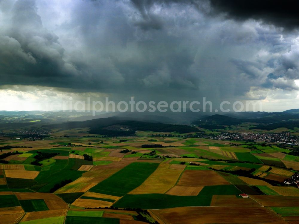 Dieburg from the bird's eye view: Cloud covered landscape in the South of Dieburg in the state of Hesse. Mountain tops of the Odenwald mountain range disappear in the clouds. In front of the mountains, fields of the valley of the river Gersprenz are located