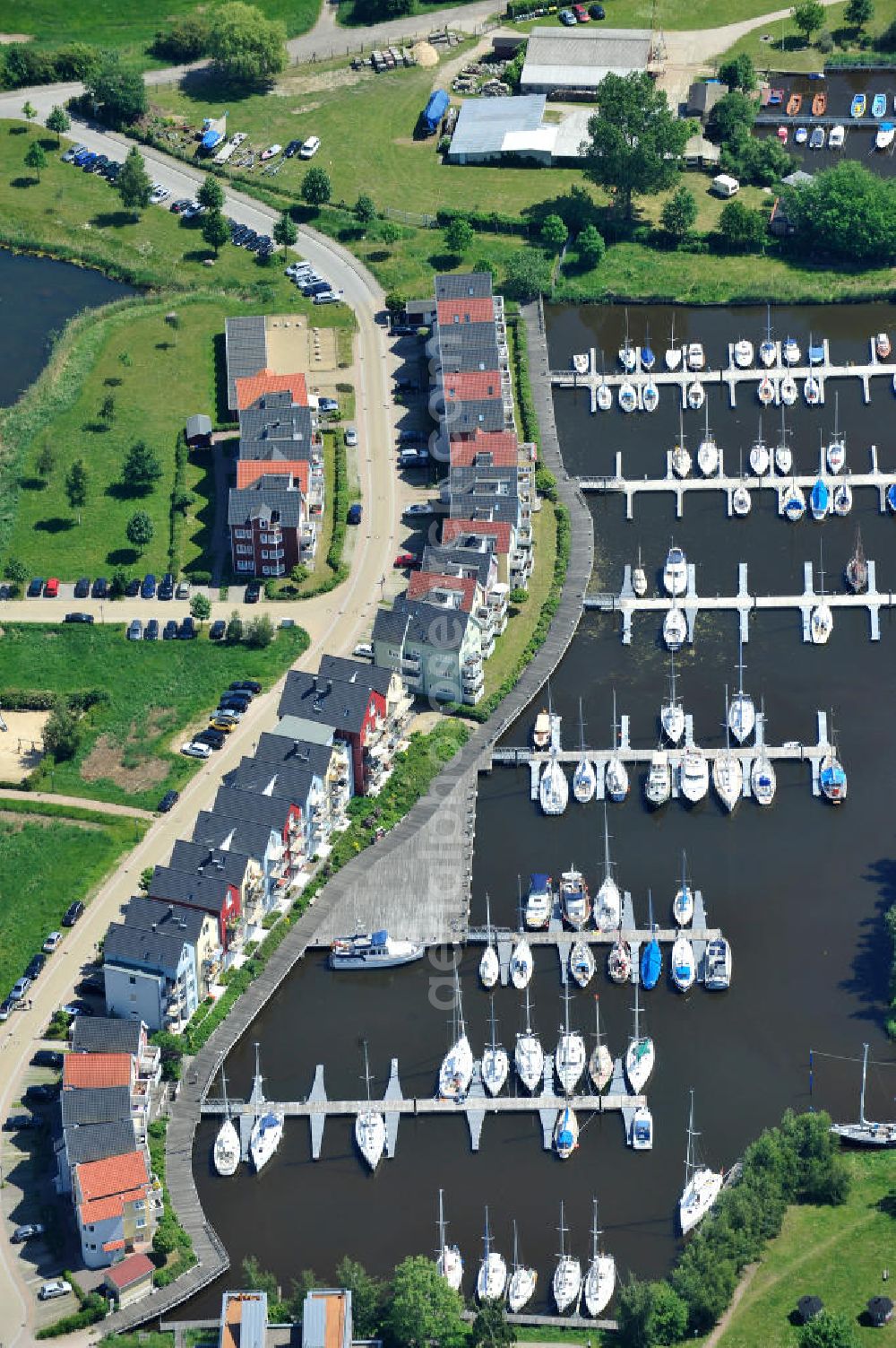 Hansestadt Greifswald from above - Yachthafen Marina am Ryck und das Skandinavische Dorf am Nordufer an der Holzteichstraße in Greifswald / Mecklenburg-Vorpommern. Yacht harbour Marina at the Ryck and the Scandinavian village at the north bank in Greifswald / Mecklenburg-Western Pomerania. HanseYachts AG