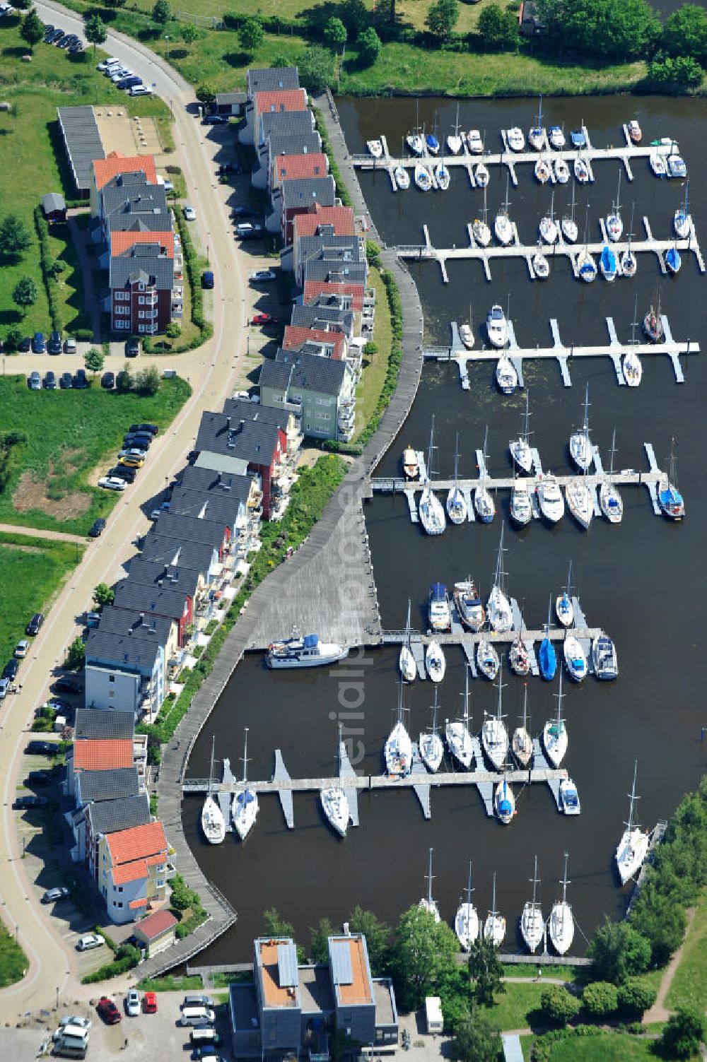 Hansestadt Greifswald from the bird's eye view: Yachthafen Marina am Ryck und das Skandinavische Dorf am Nordufer an der Holzteichstraße in Greifswald / Mecklenburg-Vorpommern. Yacht harbour Marina at the Ryck and the Scandinavian village at the north bank in Greifswald / Mecklenburg-Western Pomerania. HanseYachts AG