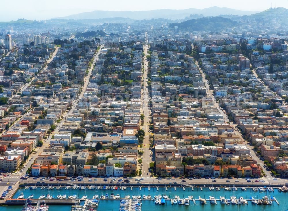 San Francisco from above - Pleasure boat marina with docks and moorings on the shore area St. Francis Yacht Club 99 Yacht Rd in San Francisco in USA. In the background, roads and residential areas of Divisadero Street, Scott street and Broderick street