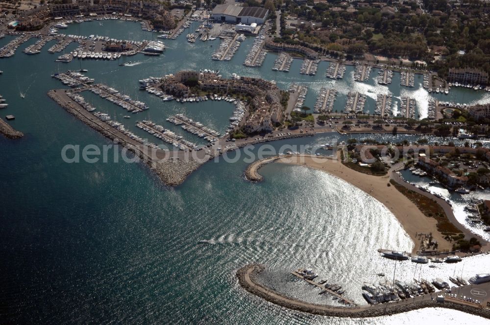 Cogolin from above - Pleasure boat marina with docks and moorings on the shore area of Golfe de Saint-Tropez in Cogolin in Provence-Alpes-Cote d'Azur, France