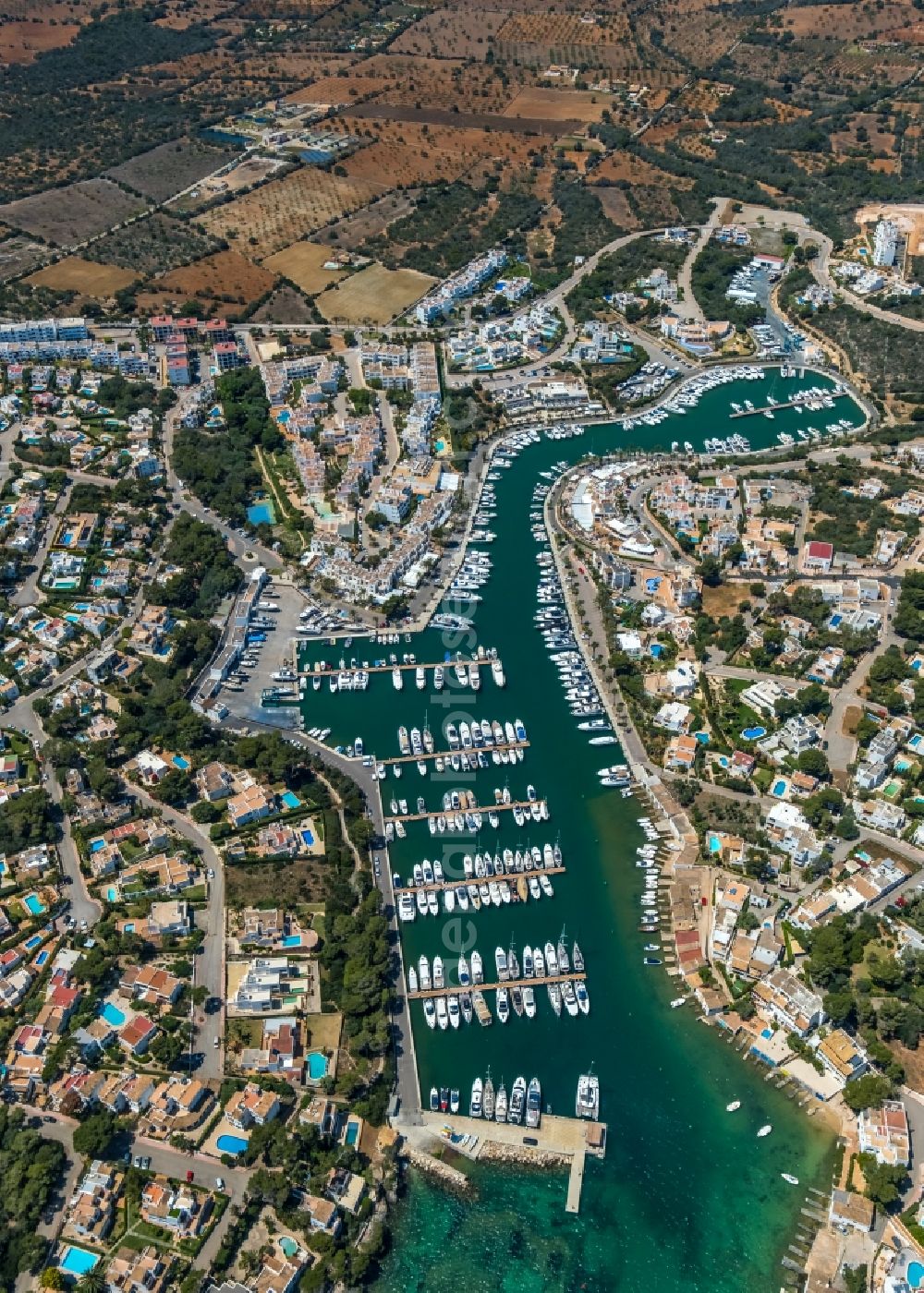 Santanyi from the bird's eye view: Pleasure boat marina with docks and moorings on the shore area of the bay Cala Llonga in Santanyi in Balearic island of Mallorca, Spain