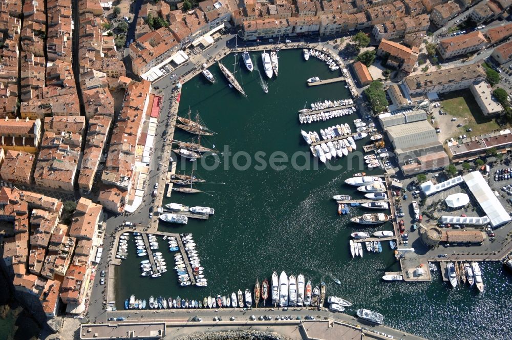 Saint-Tropez from above - Pleasure boat marina with docks and moorings on the shore area Golfe de Saint-Tropez in Saint-Tropez in Provence-Alpes-Cote d'Azur, France