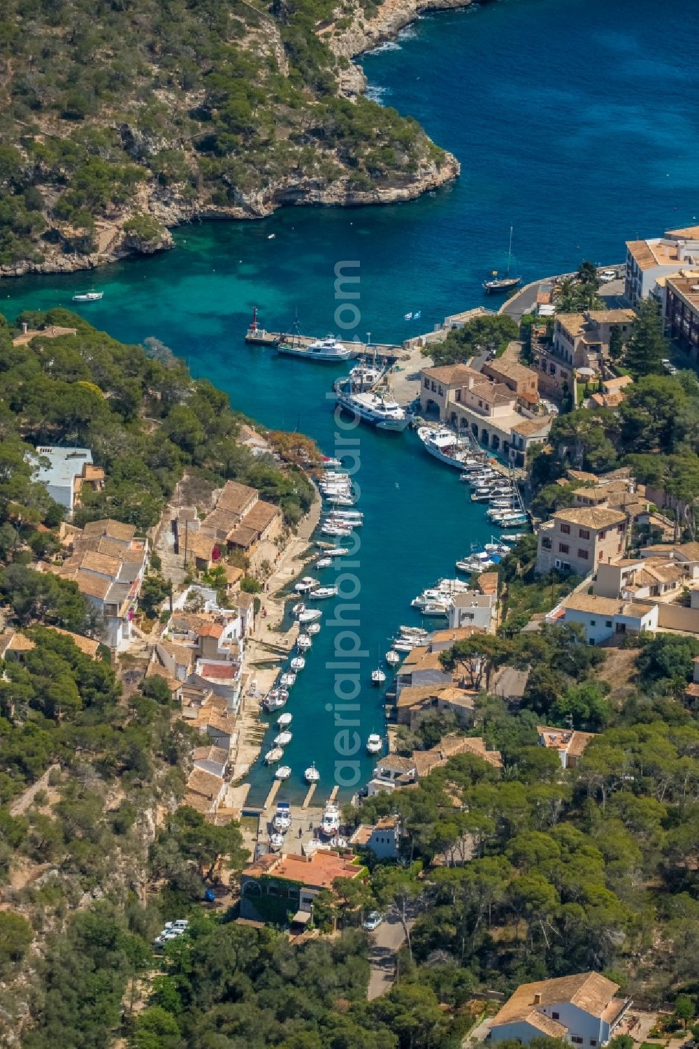 Aerial image Cala Figuera - Pleasure boat marina with docks and moorings on the shore area of the Port de Cala Figuera and Calo d'en Busques in Cala Figuera in Balearic island of Mallorca, Spain