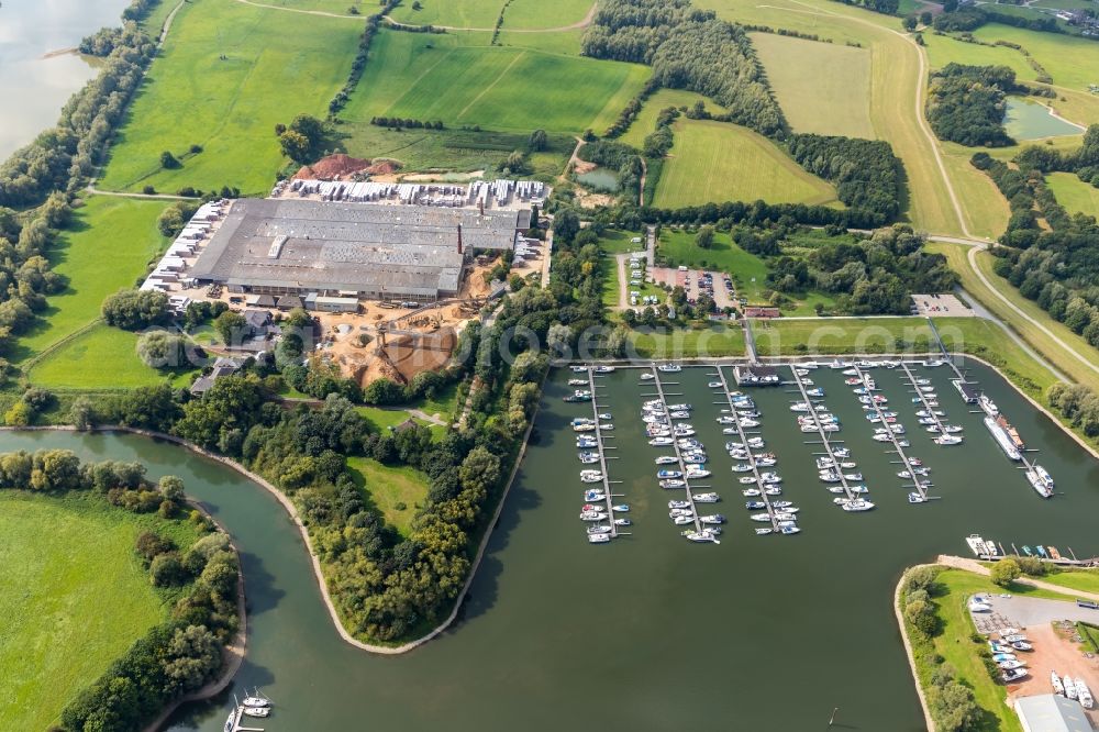 Emmerich am Rhein from the bird's eye view: Marina on the banks of the Rhine and the building of Klinkerwerke H.W. Muhr GmbH & Co. KG at Fackeldeystrasse in Emmerich am Rhein, in the state of North Rhine-Westphalia, Germany