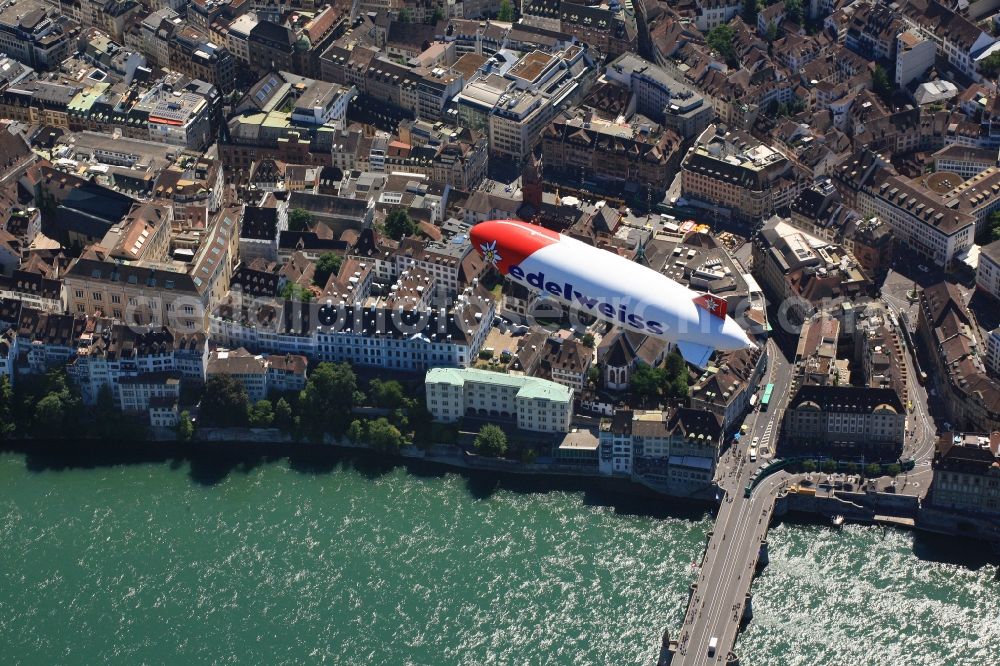 Aerial image Basel - Zeppelin D-LZZF on its flight in the airspace in Basel in Switzerland. The airship is on promotional tour for the Swiss airline Edelweiss, which celebrates its 20th anniversary. The flights with passengers over the city pass the city center, the Old Town and the river Rhine