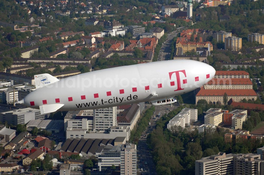 München from above - Blick auf den Zeppelin NT der Deutschen Zeppelin-Reederei in München. Der Zeppelin ist 75 Meter lang und ist bei der Flugwerft Schleißheim stationiert. Kontakt: Deutsche Zeppelin-Reederei GmbH, Allmannsweilerstrasse 132, 88046 Friedrichshafen, Tel. +49(0)7541 5900 0, Fax +49(0)7541 5900 516,