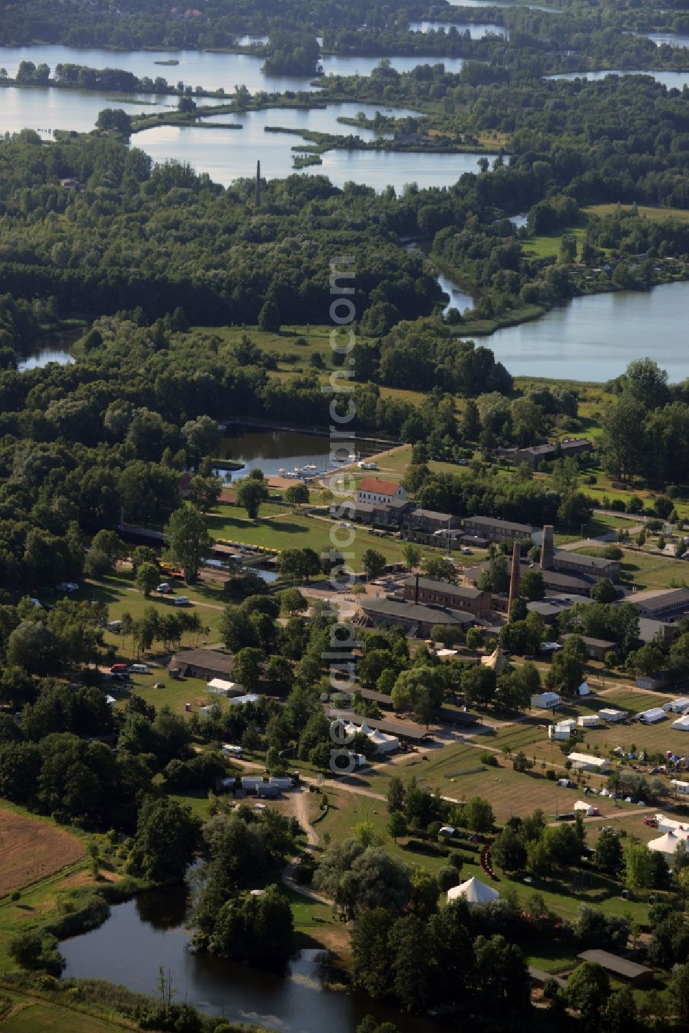 Zehdenick from above - Mildenberg brick work park in the town area of Zehdenick in the state of Brandenburg. The park is an industrial memorial, surrounded by lakes and ponds. The compound consists of the company sites of two former brick works and is located in the North of the Mildenberg part of the town