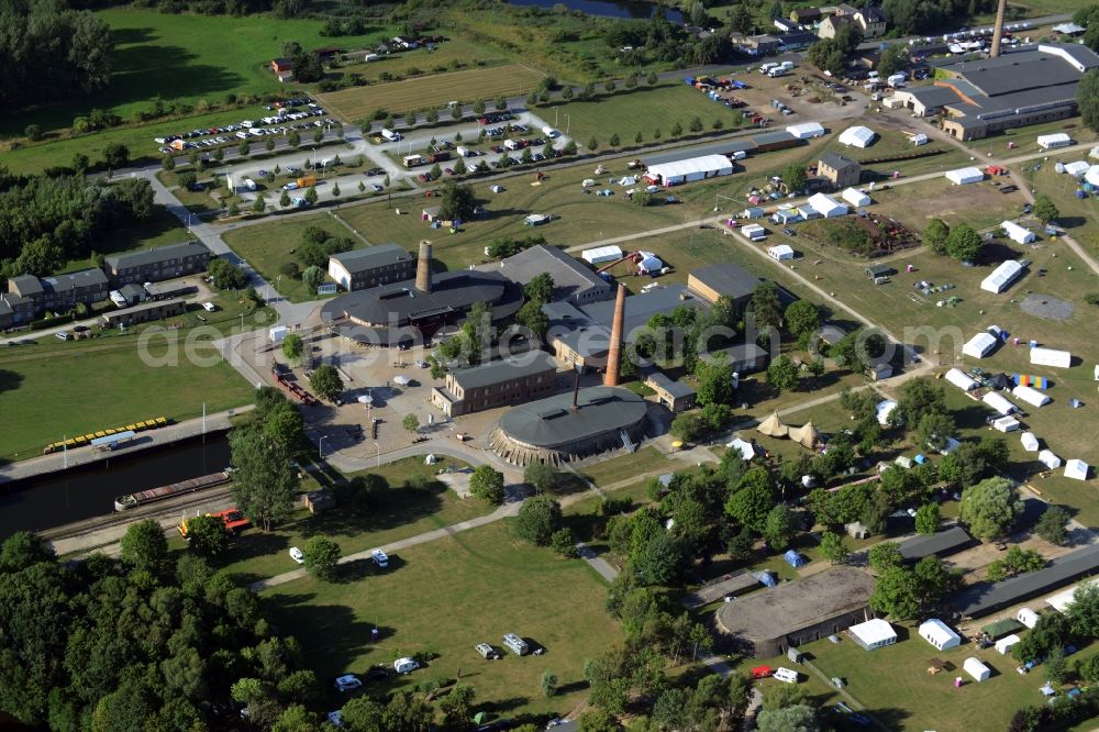 Zehdenick from the bird's eye view: Mildenberg brick work park in the town area of Zehdenick in the state of Brandenburg. The park is an industrial memorial, surrounded by lakes and ponds. The compound consists of the company sites of two former brick works and is located in the North of the Mildenberg part of the town. View of the works, chimneys and factories of the compound