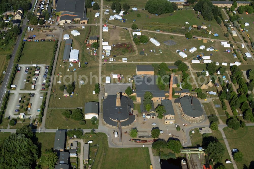 Zehdenick from the bird's eye view: Mildenberg brick work park in the town area of Zehdenick in the state of Brandenburg. The park is an industrial memorial, surrounded by lakes and ponds. The compound consists of the company sites of two former brick works and is located in the North of the Mildenberg part of the town. View of the works, chimneys and factories of the compound