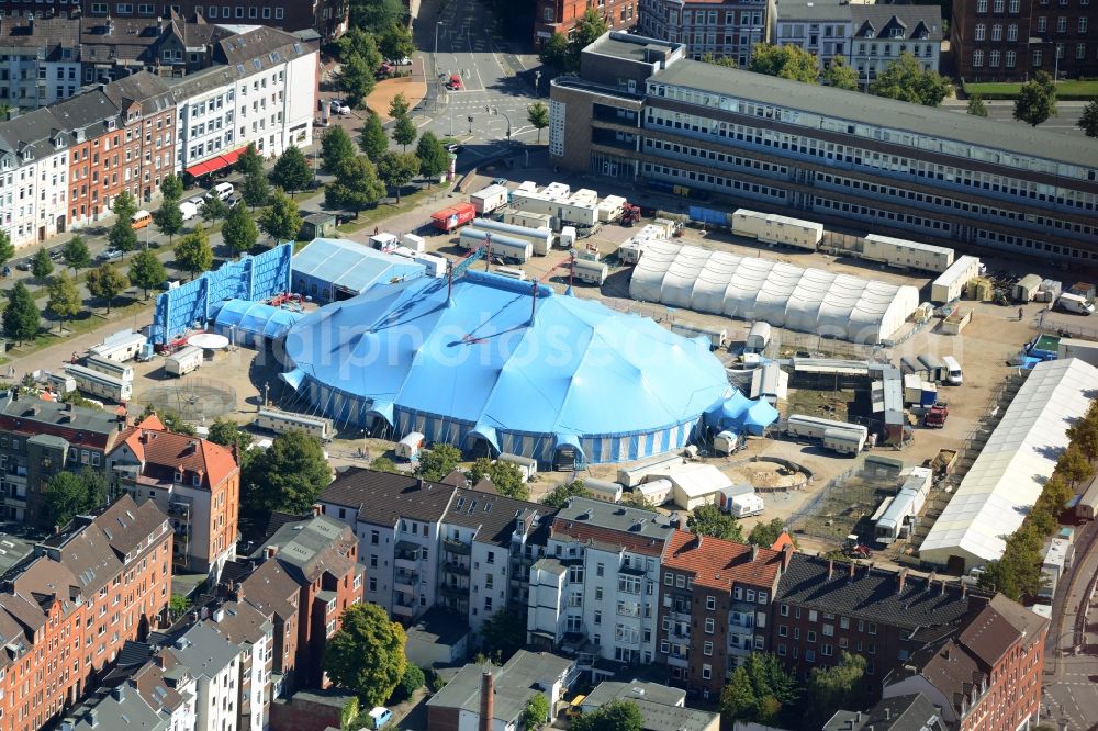 Kiel from above - Circus tent of Circus Krone on Wilhelmplatz in Kiel in the state of Schleswig-Holstein. The blue tent and the caravans are located on the square amidst residential buildings and streets