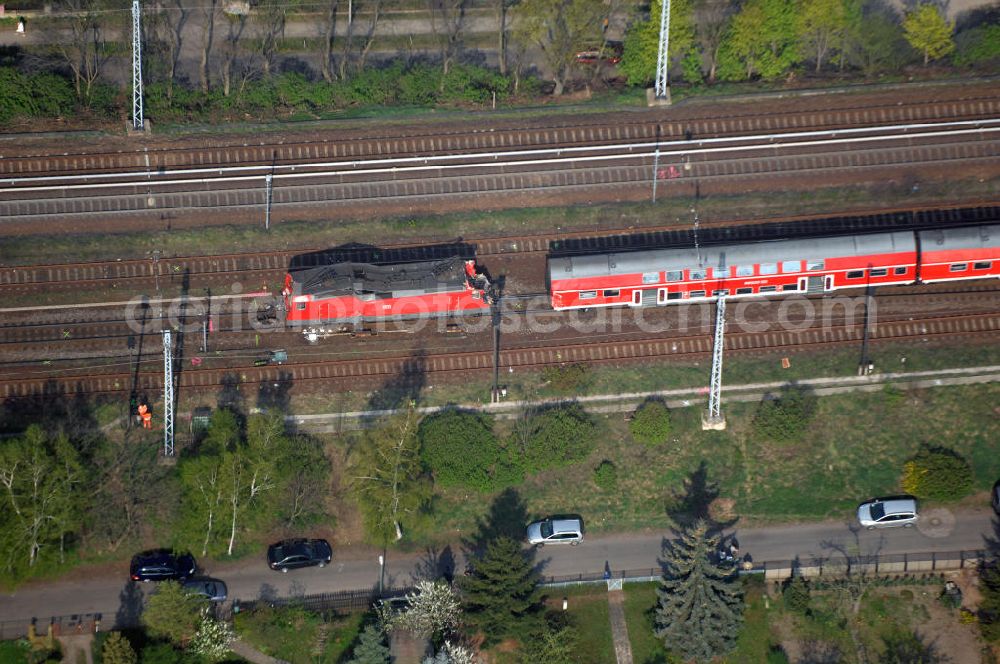 Aerial image Berlin - Blick auf einen verunglückten Nahverkehrszug der Bahn nahe dem S-Bahnhof Karow. Der Regionalexpress aus Stralsund war am späten Abend des 16. April mit 22 Reisenden und Bahn-Personal im Bahnhof Berlin-Karow auf einen langsam fahrenden Güterzug aufgefahren. Die Verletzten wurden in umliegende Krankenhäuser gebracht. Der Triebwagen und der erste Waggon des Regionalexpress waren bei dem Zusammenstoß entgleist. Der Lokführer wurde durch den Aufprall in seinem Führerhaus eingeklemmt und musste von der Feuerwehr durch die Frontscheibe befreit werden.