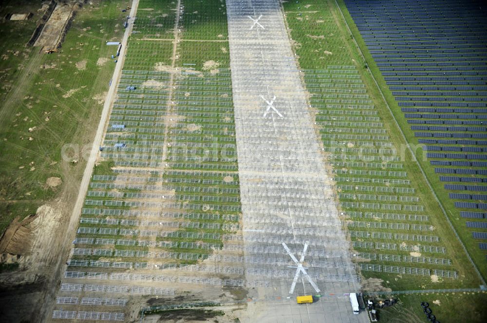 Aerial photograph Tutow - Neuer zweiter Bauabschnitt des Solarenergiepark am Flugplatz Tutow in Mecklenburg - Vorpommern. Die juwi solar GmbH errichtet hier auf ca. 21 Hektar einen Solarpark mit ca. 65.500 Quadratmetern Solarmodulfläche bei ca. 91.000200 Einzelmodulen und einer Nennleistung von ca. 6780 Kilowattstunden jährlich. Modulhersteller ist die First Solar GmbH, die Unterkonstruktionen werden von der Fa. Schletter Leichtmetallbau GmbH errichtet. View of the second section of the solar energy park at the airport Tutow in Mecklenburg - Western Pomerania.