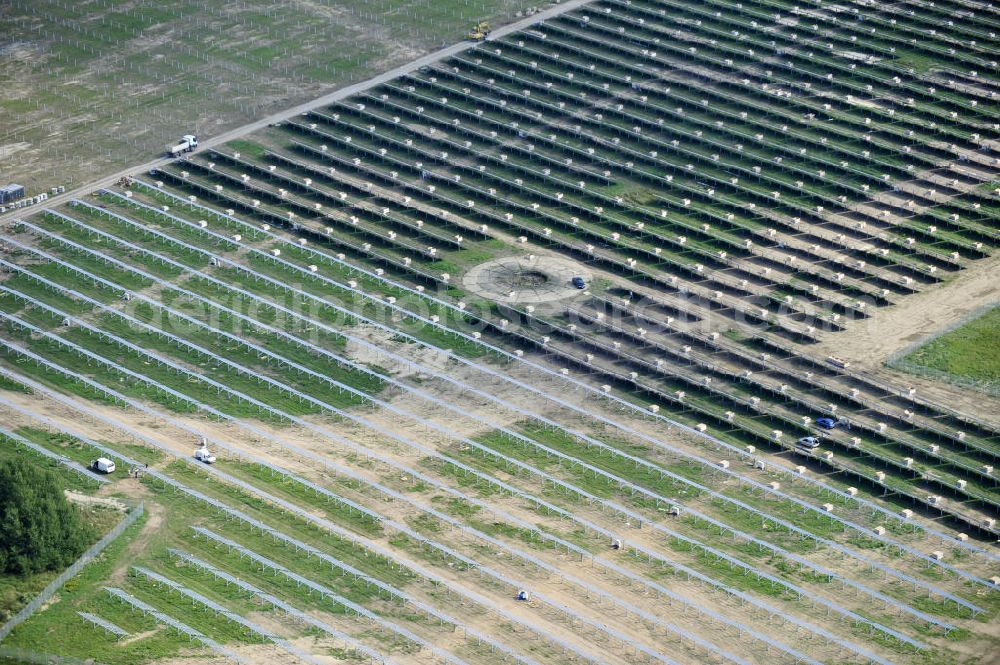 Tutow from the bird's eye view: Neuer zweiter Bauabschnitt des Solarenergiepark am Flugplatz Tutow in Mecklenburg - Vorpommern. Die juwi solar GmbH errichtet hier auf ca. 21 Hektar einen Solarpark mit ca. 65.500 Quadratmetern Solarmodulfläche bei ca. 91.000200 Einzelmodulen und einer Nennleistung von ca. 6780 Kilowattstunden jährlich. Modulhersteller ist die First Solar GmbH, die Unterkonstruktionen werden von der Fa. Schletter Leichtmetallbau GmbH errichtet. View of the second section of the solar energy park at the airport Tutow in Mecklenburg - Western Pomerania.