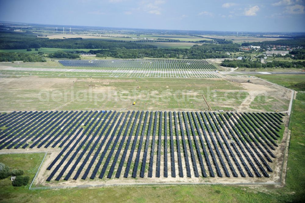 Tutow from the bird's eye view: Neuer zweiter Bauabschnitt des Solarenergiepark am Flugplatz Tutow in Mecklenburg - Vorpommern. Die juwi solar GmbH errichtet hier auf ca. 21 Hektar einen Solarpark mit ca. 65.500 Quadratmetern Solarmodulfläche bei ca. 91.000200 Einzelmodulen und einer Nennleistung von ca. 6780 Kilowattstunden jährlich. Modulhersteller ist die First Solar GmbH, die Unterkonstruktionen werden von der Fa. Schletter Leichtmetallbau GmbH errichtet. View of the second section of the solar energy park at the airport Tutow in Mecklenburg - Western Pomerania.