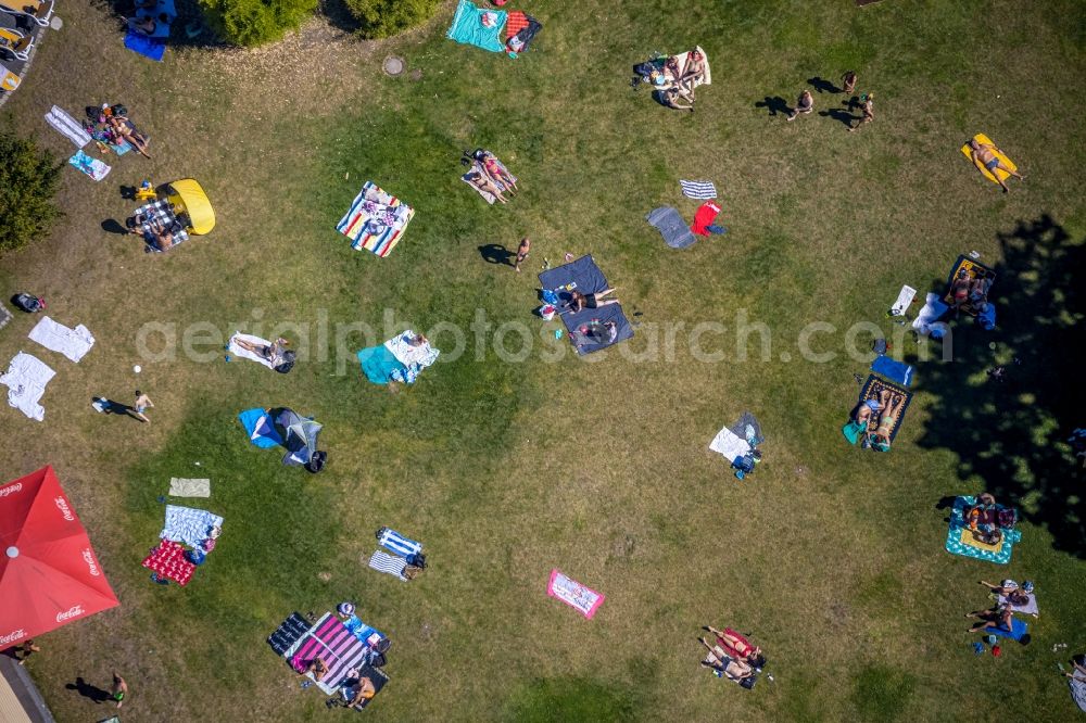 Vertical aerial photograph Dorsten - Vertical aerial view from the satellite perspective of the bathers on the lawn by the pool of the swimming pool Atlantis on Konrad-Adenauer-Platz in Dorsten in the state North Rhine-Westphalia, Germany