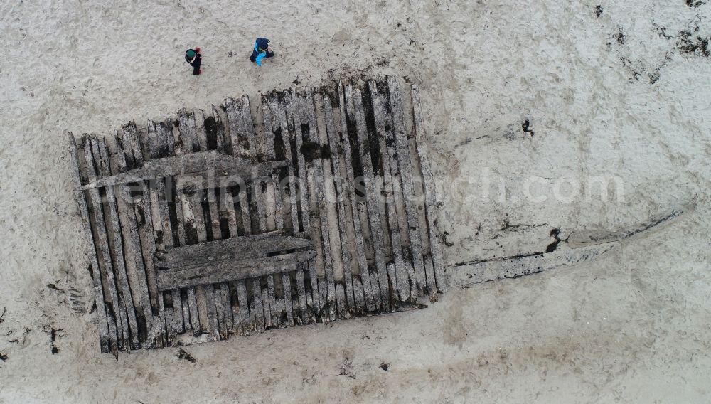 Vertical aerial photograph Glowe - Vertical aerial view from the satellite perspective of the salvage work on the ship - wreck of an old wooden merchant ship on the sandy beach in Glowe on the coast of the island of Ruegen in the state Mecklenburg-Western Pomerania, Germany