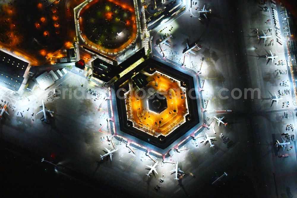 Vertical aerial photograph Berlin - Vertical aerial view from the satellite perspective of the Night lighting Flight operations at the terminal of the airport Berlin - Tegel