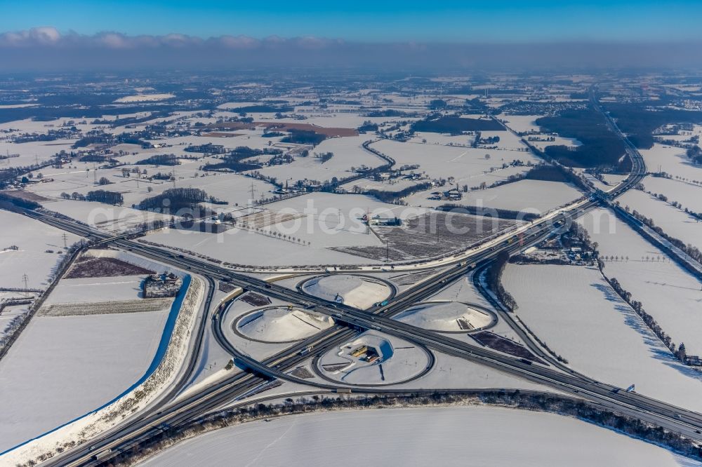 Vertical aerial photograph Kamen - Wintry snowy autumnal discolored vegetation view Traffic flow at the intersection- motorway A 1 A2 Kamener Kreuz in Kamen in the state North Rhine-Westphalia, Germany