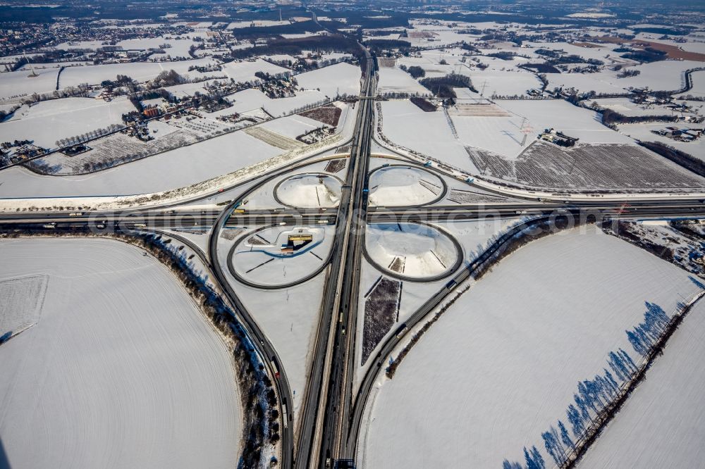 Vertical aerial photograph Kamen - Wintry snowy autumnal discolored vegetation view Traffic flow at the intersection- motorway A 1 A2 Kamener Kreuz in Kamen in the state North Rhine-Westphalia, Germany